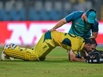 Glenn Maxwell is being attended by a physio during the 2023 ICC Men's Cricket World Cup one-day international (ODI) match between Australia and Afghanistan.