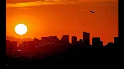 A jet takes flight from Sky Harbor International Airport as the sun sets over Phoenix, July 12, 2023. Arizona’s Maricopa County, the hottest metropolitan area in the U.S. and home to Phoenix, set a new record Thursday, Oct. 19, 2023, for annual heat-associated deaths. County officials said the 425 deaths were confirmed as of Oct. 14. Another 199 deaths remain under investigation. (AP) A jet takes flight from Sky Harbor International Airport as the sun sets over Phoenix, July 12, 2023. Arizona’s Maricopa County, the hottest metropolitan area in the U.S. and home to Phoenix, set a new record Thursday, Oct. 19, 2023, for annual heat-associated deaths. County officials said the 425 deaths were confirmed as of Oct. 14. Another 199 deaths remain under investigation. (AP)