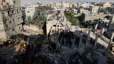 Palestinians search for casualties at the site of Israeli strikes on houses, amid the ongoing conflict between Israel and Palestinian Islamist group Hamas (Reuters)