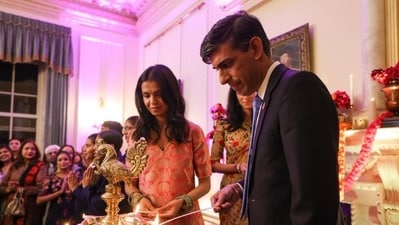 UK Prime Minister Rishi Sunak, wife Akshata Murthy, lighting diyas at 10 Downing Street. UK Prime Minister Rishi Sunak, wife Akshata Murthy, lighting diyas at 10 Downing Street.