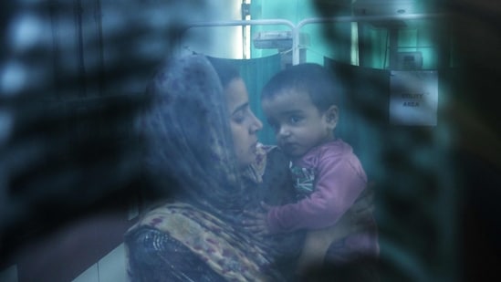 Delhi Pollution news: In this picture taken on November 7, 2023, a doctor (not pictured) examines the X-ray of child with breathing difficulties at the emergency ward of the government-run Chacha Nehru Bal Chikitsalaya children hospital in New Delhi. Delhi Pollution news: In this picture taken on November 7, 2023, a doctor (not pictured) examines the X-ray of child with breathing difficulties at the emergency ward of the government-run Chacha Nehru Bal Chikitsalaya children hospital in New Delhi.