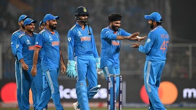 India's captain Rohit Sharma (R) celebrates with teammates after their win at the end of the 2023 ICC World Cup match against South Africa (AFP)
