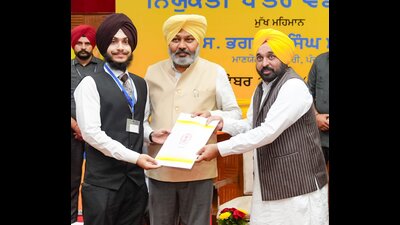 Chief minister Bhagwant Mann handing over appointment letter to a recruit in Chandigarh on Friday. (Sourced) Chief minister Bhagwant Mann handing over appointment letter to a recruit in Chandigarh on Friday. (Sourced)