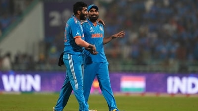 India's Jasprit Bumrah, left, celebrates with teammate Mohammed Shami as they leave the field after India win their ICC Men's Cricket World Cup match against England. (AP) India's Jasprit Bumrah, left, celebrates with teammate Mohammed Shami as they leave the field after India win their ICC Men's Cricket World Cup match against England. (AP)