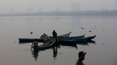 Fishermen are silhouetted as they anchor their boats in Karachi. (Reuters)