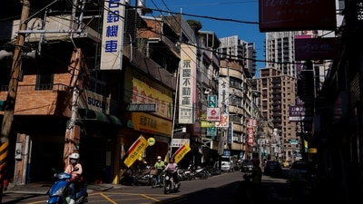 People commute on their motorbikes in the morning in New Taipei City, Taiwan November 9, 2023. (Reuters)