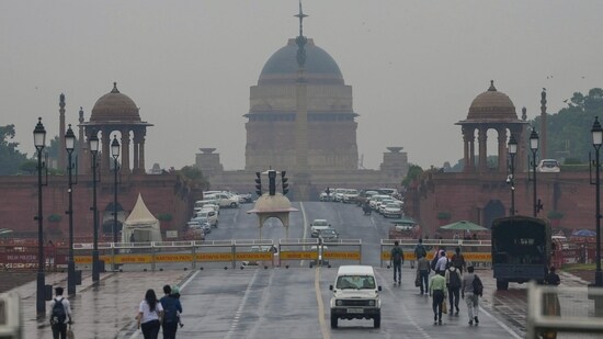 People move on the Kartavya Path after overnight rain, in New Delhi, Friday, Nov. 10. People move on the Kartavya Path after overnight rain, in New Delhi, Friday, Nov. 10.