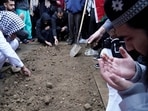 Muslim community members mourn Wadea Al Fayoume at his grave in LaGrange, Ill., Monday, Oct. 16, 2023. An Illinois landlord accused of fatally stabbing the 6-year-old Muslim boy and seriously wounding his mother was charged with a hate crime after police and relatives said he singled out the victims because of their faith and as a response to the war between Israel and Hamas. (AP Photo/Nam Y. Huh)
