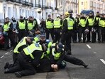 Police officers detain a man in the street close to the 'National March For Palestine' in central London on November 11, 2023. Police officers detain a man in the street close to the 'National March For Palestine' in central London on November 11, 2023.