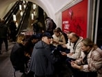 People sit in a metro station to shelter from an air raid, during Russia's attack on Ukraine, in Kyiv, Ukraine, November 11, 2023. 