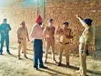 Police officials inspect the site in Ambala district where the illicit liquor was being produced, on Saturday. 