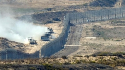 A picture taken from southern Israel near the border with the Gaza Strip shows Israeli army vehicles crossing back into Israel from Gaza, on November 7, 2023. (AFP) A picture taken from southern Israel near the border with the Gaza Strip shows Israeli army vehicles crossing back into Israel from Gaza, on November 7, 2023. (AFP)