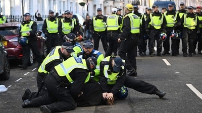 Police officers detain a man in the street close to the 'National March For Palestine' in central London on November 11, 2023. (AFP) Police officers detain a man in the street close to the 'National March For Palestine' in central London on November 11, 2023. (AFP)