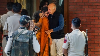 Manisha Sisodia hugs his ailing wife as he leaves for jail after spending some time at his home on Saturday. (PTI) Manisha Sisodia hugs his ailing wife as he leaves for jail after spending some time at his home on Saturday. (PTI)