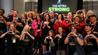 SAG-AFTRA union President Fran Drescher and SAG-AFTRA chief negotiator Duncan Crabtree-Ireland pose for a group photo. (REUTERS)