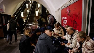 People sit in a metro station to shelter from an air raid, during Russia's attack on Ukraine, in Kyiv, Ukraine, November 11, 2023. (Reuters)