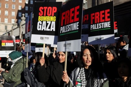 Demonstrators hold placards on the day of the protest in solidarity with Palestinians in Gaza, amid the ongoing conflict between Israel and the Palestinian Islamist group Hamas, in London, Britain, November 11, 2023. (Reuters/Hollie Adams)