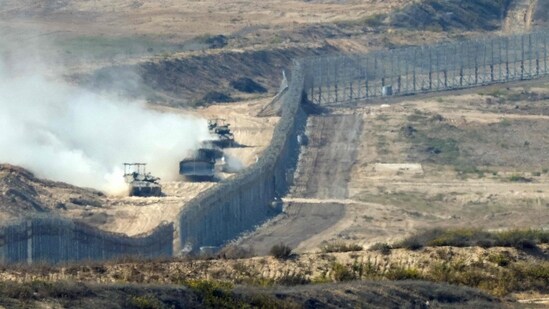 A picture taken from southern Israel near the border with the Gaza Strip shows Israeli army vehicles crossing back into Israel from Gaza, on November 7, 2023. (AFP)