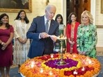 US President Joe Biden lights a lamp as First lady Jill Biden and Vice-President Kamala Harris look on during an event to celebrate Diwali, at the White House in Washington. (PTI) US President Joe Biden lights a lamp as First lady Jill Biden and Vice-President Kamala Harris look on during an event to celebrate Diwali, at the White House in Washington. (PTI)