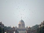 A flock of birds flies over the Rashtrapati Bhavan amid smog as the air quality in the national capital slightly improves in New Delhi. (ANI)
