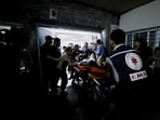 An injured person is assisted at Shifa Hospital after an Israeli air strike hit the nearby Al-Ahli Hospital