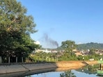 This photo taken on November 7 shows a man watching smoke rising from the direction of a Myanmar military base in Lashio township.