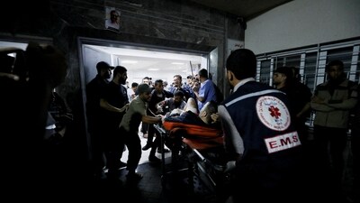 An injured person is assisted at Shifa Hospital after an Israeli air strike hit the nearby Al-Ahli Hospital (REUTERS)
