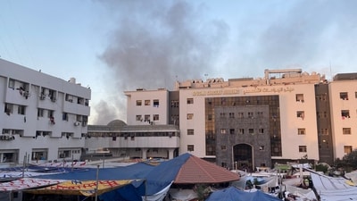 Smoke rises as displaced Palestinians take shelter at Al Shifa hospital, amid the ongoing conflict between Hamas and Israel, in Gaza City on November 8. (Reuters)