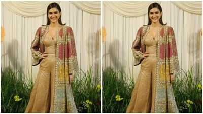 Kriti Sanon looked stunning as ever in a golden co-ord set and further teamed it with a heavily embellished multicoloured ethnic long jacket.&nbsp; (Instagram/@pallav_paliwal)