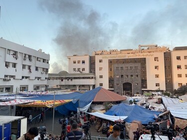 Smoke rises as displaced Palestinians take shelter at Al Shifa hospital, amid the ongoing conflict between Hamas and Israel, in Gaza City, November 8, 2023. (Reuters)