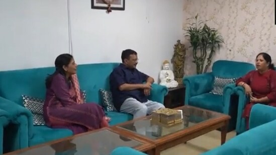 Delhi CM Arvind Kejriwal with Sanjay Singh’s family. (ANI)