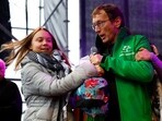 A man holds a microphone with activist Greta Thunberg after he jumped on the stage during her speech as she attends The March for Climate and Justice to demand political change before the elections in Amsterdam, Netherlands, on November 12. 