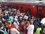Passengers gather to board a train to reach their hometowns for the Chhath Puja festival at Patna Junction in Bihar.