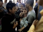EDITORS NOTE: Graphic content / TOPSHOT - A wounded Palestinian child and other members of the Baraka family arrive at Nasser Hospital in Khan Yunis, following Israeli air strikes that hit their building in the southern Gaza Strip city on November 13, 2023. Israel is facing intense international pressure to minimise civilian suffering amid a massive air and ground operation that Hamas authorities say has already killed more than 11,000 people, including thousands of children. The military campaign came after Hamas fighters broke through the militarised border with Israel on October 7, killing around 1,200 people, mostly civilians, and taking about 240 people hostage, according to the most recent Israeli figures.