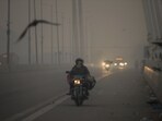 Commuters travel on the Signature Bridge amid low visibility as the air quality again goes down to the 'Poor' category in New Delhi on November 13. Commuters travel on the Signature Bridge amid low visibility as the air quality again goes down to the 'Poor' category in New Delhi on November 13.