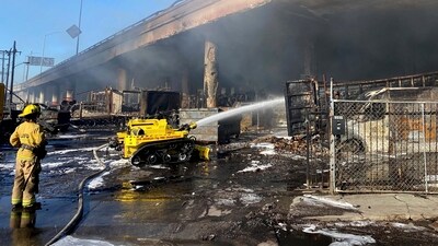 In this photo provided by the California Department of Transportation, a Los Angeles firefighter uses a robotic hose to douse a fire under Interstate 10 that severely damaged the overpass in an industrial zone near downtown Los Angeles, Saturday, Nov. 11, 2023 (AP11_12_2023_000005A) (AP) In this photo provided by the California Department of Transportation, a Los Angeles firefighter uses a robotic hose to douse a fire under Interstate 10 that severely damaged the overpass in an industrial zone near downtown Los Angeles, Saturday, Nov. 11, 2023 (AP11_12_2023_000005A) (AP)