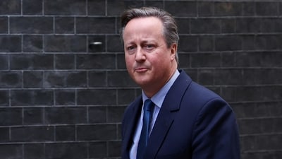 Former British Prime Minister David Cameron walks outside 10 Downing Street in London, Britain. (Reuters)