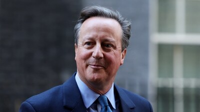 Britain's former Prime Minister and newly appointed Foreign Secretary David Cameron walks outside 10 Downing Street in London on November 13. (Reuters)