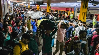 New Delhi: Passengers wait for trains to their hometowns, ahead of the 'Chhath Puja' festival at New Delhi railway station on Nov. 11. (PTI) New Delhi: Passengers wait for trains to their hometowns, ahead of the 'Chhath Puja' festival at New Delhi railway station on Nov. 11. (PTI)