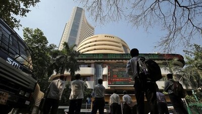People look at a screen displaying the Sensex results on the facade of the Bombay Stock Exchange (BSE) building in Mumbai. (REUTERS)