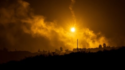 This picture taken from a position near Sderot along the Israeli border with the Gaza Strip on November 13, 2023, shows flares dropped by Israeli forces above the Palestinian territory amid ongoing battles between Israel and the Hamas movement. (AFP)