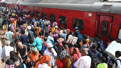 Passengers gather to board a train to reach their hometowns for the Chhath Puja festival at Patna Junction in Bihar. (Santosh Kumar/Hindustan Times)