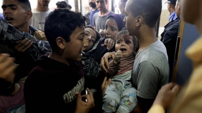 EDITORS NOTE: Graphic content / TOPSHOT - A wounded Palestinian child and other members of the Baraka family arrive at Nasser Hospital in Khan Yunis, following Israeli air strikes that hit their building in the southern Gaza Strip city on November 13, 2023. Israel is facing intense international pressure to minimise civilian suffering amid a massive air and ground operation that Hamas authorities say has already killed more than 11,000 people, including thousands of children. The military campaign came after Hamas fighters broke through the militarised border with Israel on October 7, killing around 1,200 people, mostly civilians, and taking about 240 people hostage, according to the most recent Israeli figures. (AFP) EDITORS NOTE: Graphic content / TOPSHOT - A wounded Palestinian child and other members of the Baraka family arrive at Nasser Hospital in Khan Yunis, following Israeli air strikes that hit their building in the southern Gaza Strip city on November 13, 2023. Israel is facing intense international pressure to minimise civilian suffering amid a massive air and ground operation that Hamas authorities say has already killed more than 11,000 people, including thousands of children. The military campaign came after Hamas fighters broke through the militarised border with Israel on October 7, killing around 1,200 people, mostly civilians, and taking about 240 people hostage, according to the most recent Israeli figures. (AFP)