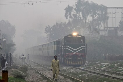 Commuters make their way along the railway tracks amid smoggy conditions in Lahore on November 7, 2023. (AFP) Commuters make their way along the railway tracks amid smoggy conditions in Lahore on November 7, 2023. (AFP)