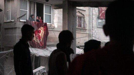 Israel-Hamas War: Palestinians look for survivors under the rubble of a destroyed house following an Israeli airstrike in Khan Younis refugee camp. (AP)