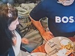 Snapshot of the woman adding hair to food. 