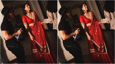 Alia's red saree is from the shelves of ace designer Manish Malhotra and features a plunging neck blouse with intricate gold embroidery on the border. Her saree is adorned with gold sequin detailing all over which she draped elegantly around her. (Instagram/@stylebyami) Alia's red saree is from the shelves of ace designer Manish Malhotra and features a plunging neck blouse with intricate gold embroidery on the border. Her saree is adorned with gold sequin detailing all over which she draped elegantly around her. (Instagram/@stylebyami)