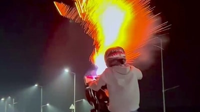 Screengrab from viral video showing a biker performing stunts and bursting firecrackers while riding motorcycle. (ANI) Screengrab from viral video showing a biker performing stunts and bursting firecrackers while riding motorcycle. (ANI)