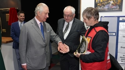 Britain's King Charles and Queen Camilla (not pictured) visit FareShare Didcot to launch the Coronation Food Project on his birthday, in Didcot, Britain, November 14, 2023. The King bought a copy of the Big Issue from seller Kelvin along with Lord John Bird the founder of the Big Issue. Ian Vogler/Pool via REUTERS (via REUTERS)
