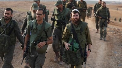 Israel-Hamas War: Israeli army soldiers return after searching for human remains following the October 7 attack carried out by Palestinian militants from the Gaza Strip. (AFP) Israel-Hamas War: Israeli army soldiers return after searching for human remains following the October 7 attack carried out by Palestinian militants from the Gaza Strip. (AFP)